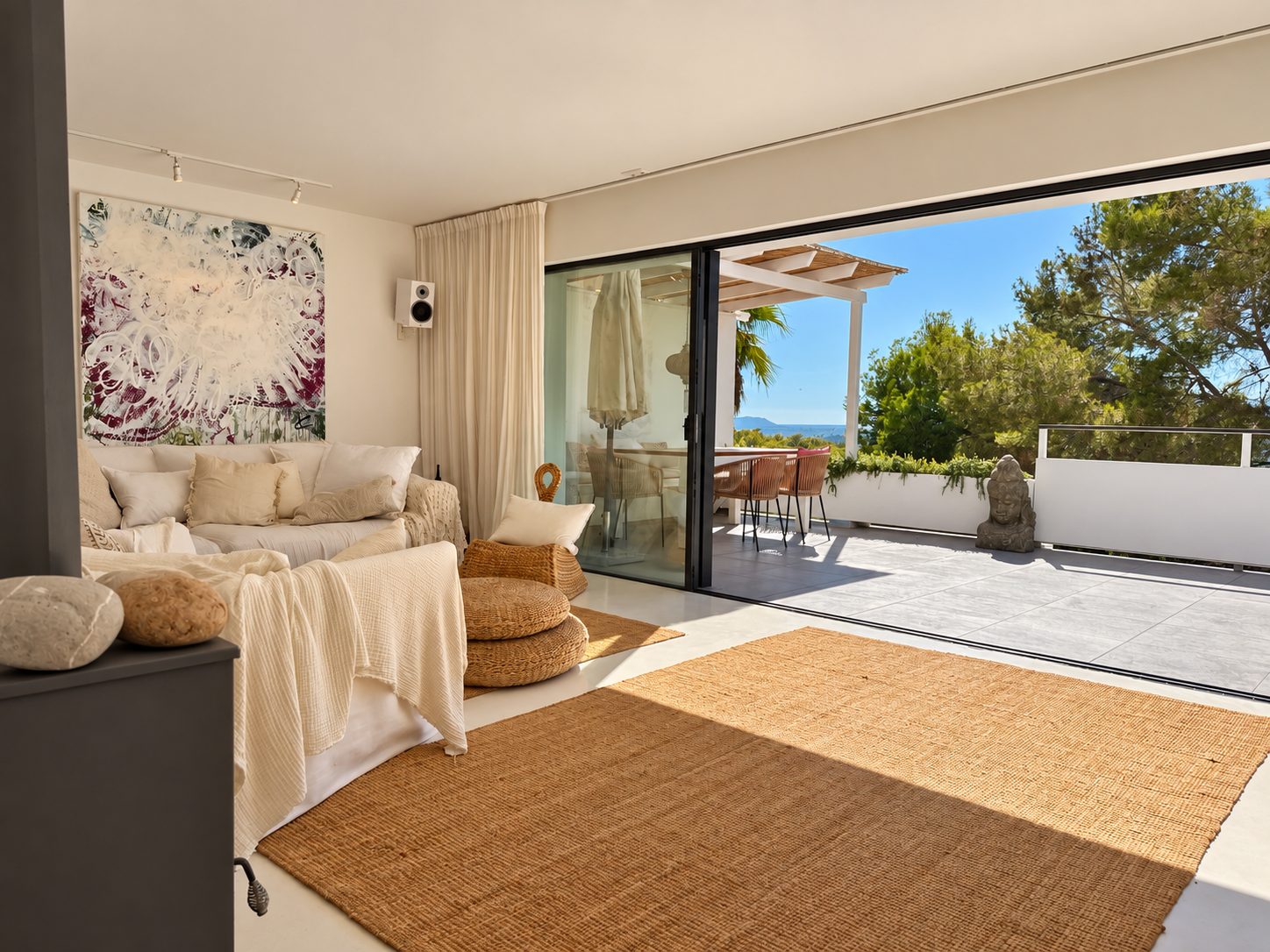 Open living room with sliding doors to the terrace and views over the hills